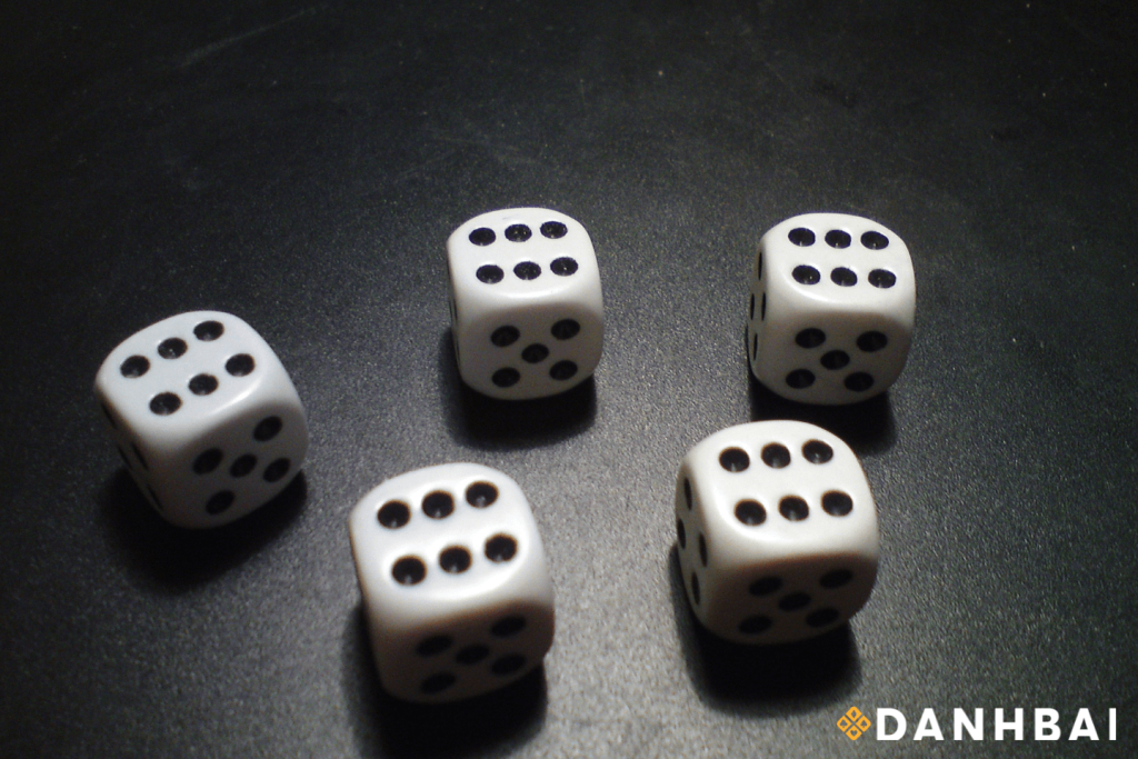 A set of five dice, each showing the number six.