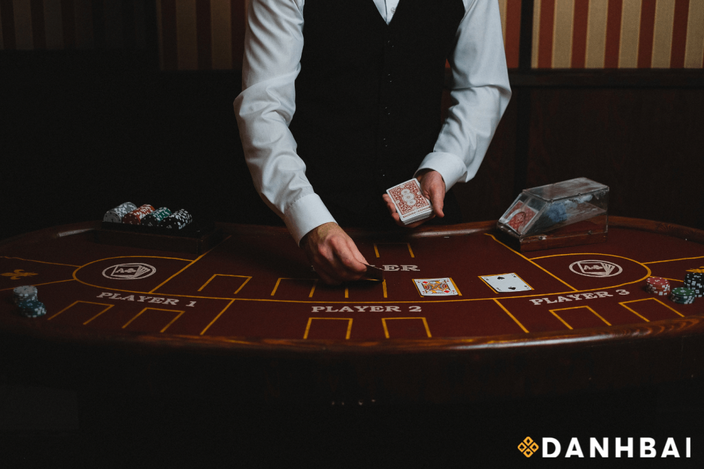 Poker dealer professionally dealing playing cards onto the poker table.